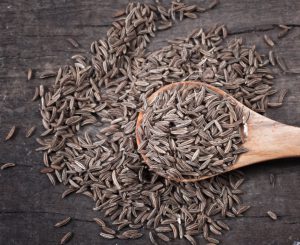 Indian cumin seeds in a spoon