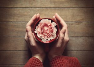 woman holding hot cup of tea