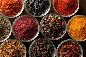 Various spices in glass bowls, close up